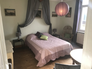 A large bedroom which gets a lot of light with a large window : 1 double bed with net curtain and a wardrobe « lingère ».